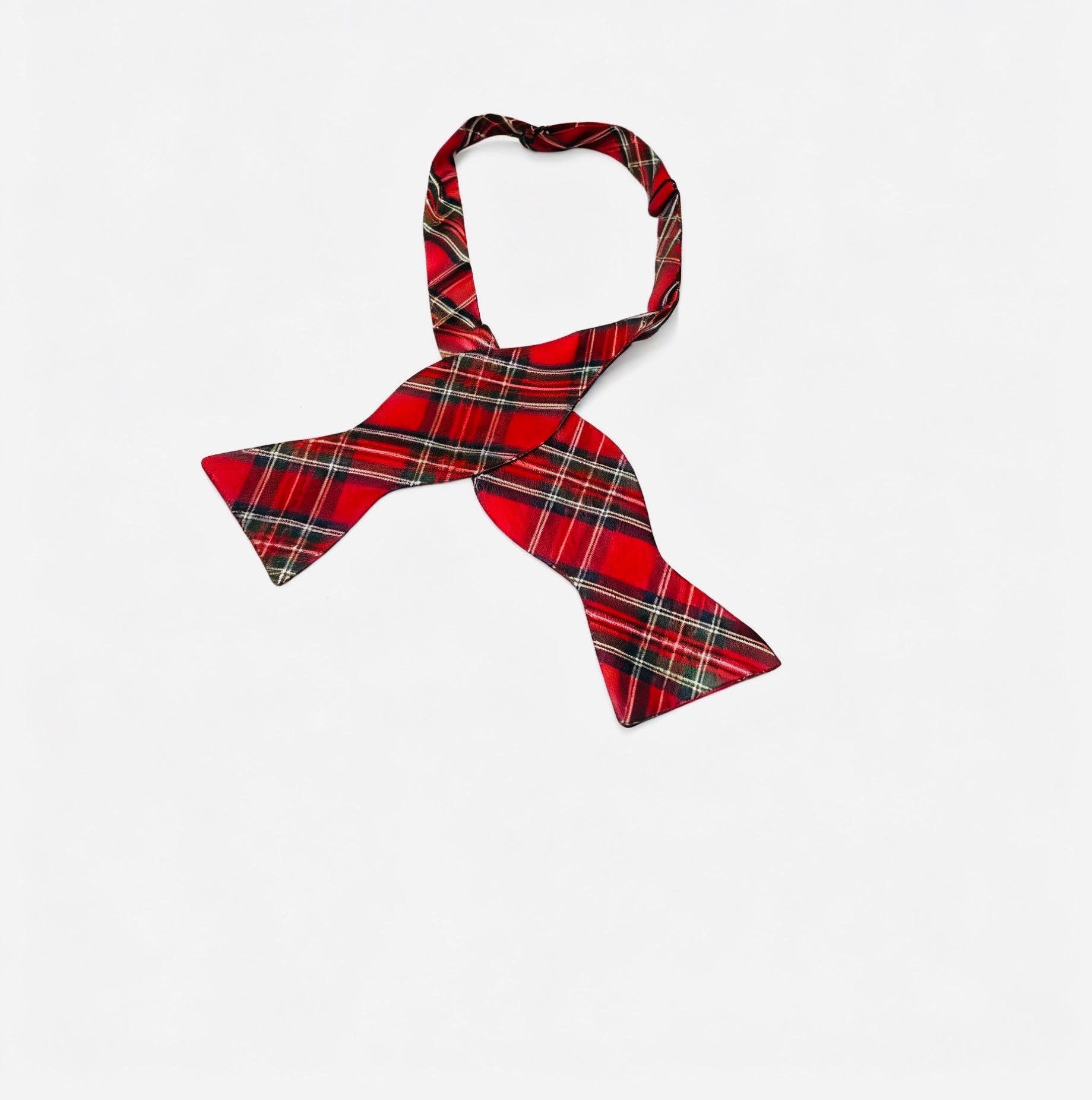Red plaid bow tie on a light gray background