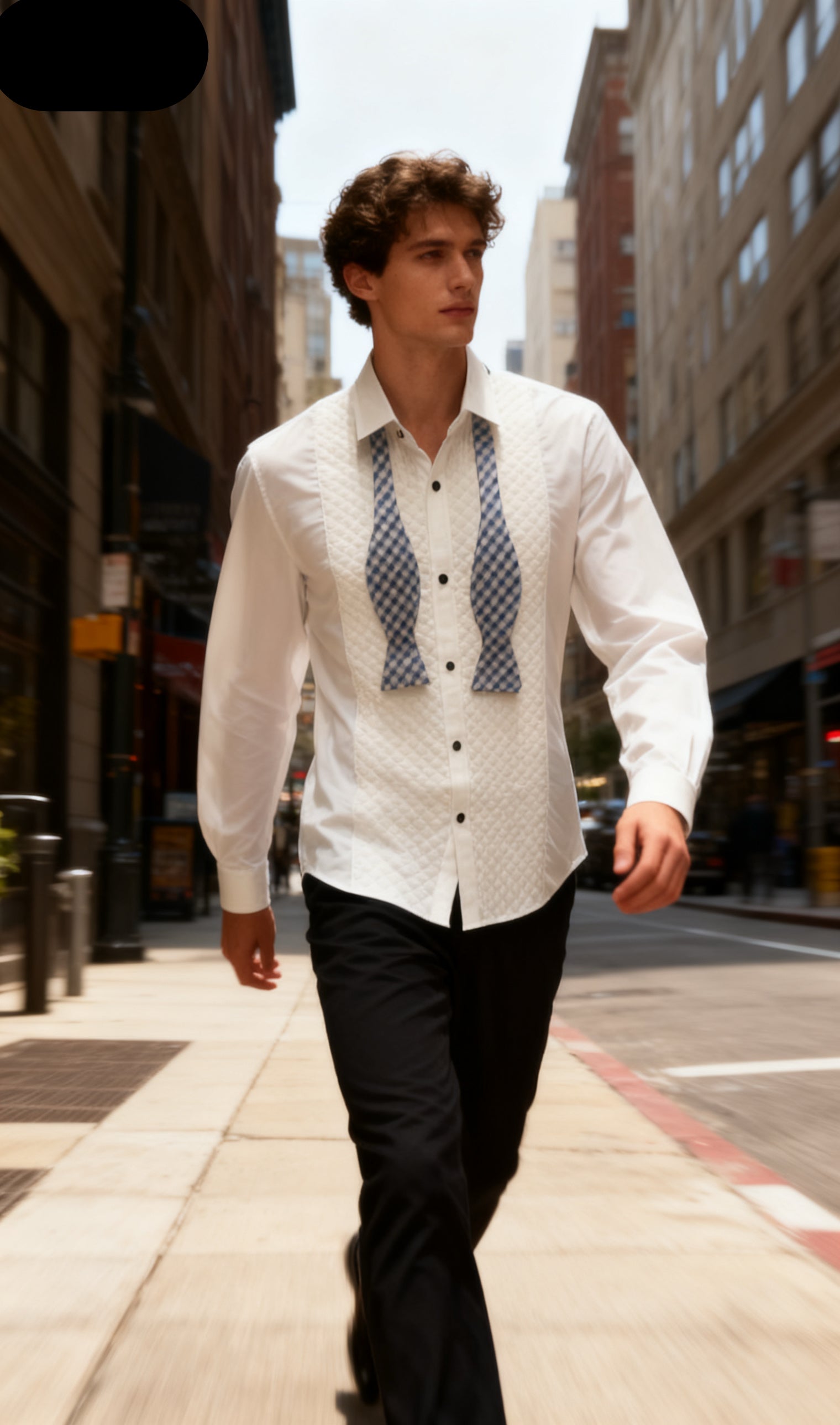 Man walking on a city street wearing a white shirt with suspenders.